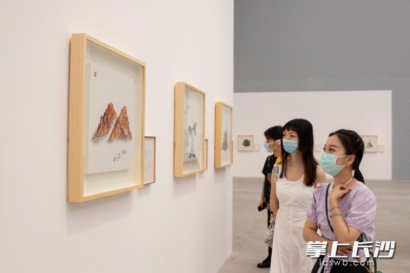 几位美术爱好者正在观看展览。