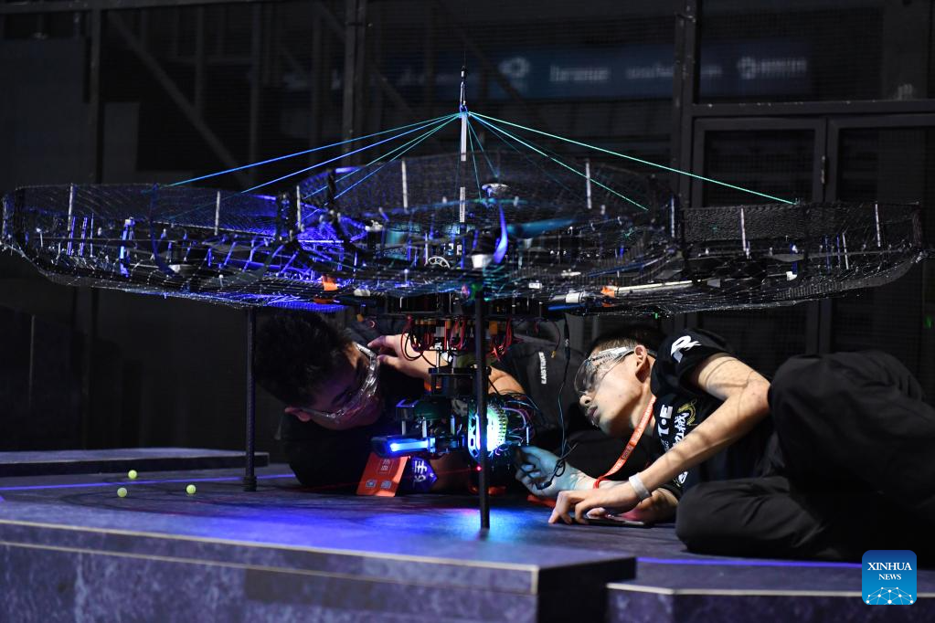 Contestants of team TOE from Dalian Jiaotong University test their robots during the RoboMaster 2023 University Championship Regional Competition (South China) in Changsha, central China's Hunan Province, May 28, 2023. The four-day regional competition concluded in Changsha on Sunday, with team RobotPilots from Shenzhen University winning the first place and team TOE from Dalian Jiaotong University being the second. (Xinhua/Chen Zhenhai)