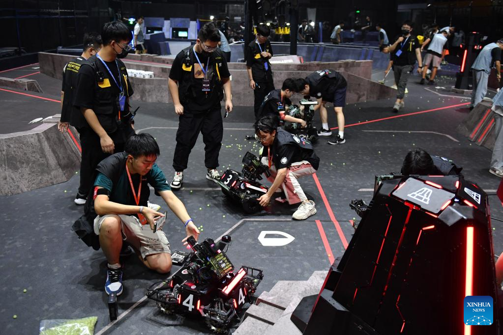 Contestants of team RobotPilots from Shenzhen University test their robots during the RoboMaster 2023 University Championship Regional Competition (South China) in Changsha, central China's Hunan Province, May 28, 2023. The four-day regional competition concluded in Changsha on Sunday, with team RobotPilots from Shenzhen University winning the first place and team TOE from Dalian Jiaotong University being the second. (Xinhua/Chen Zhenhai)